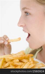 Teenage girl eating French fries