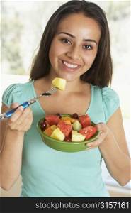 Teenage Girl Eating Fresh Fruit Salad