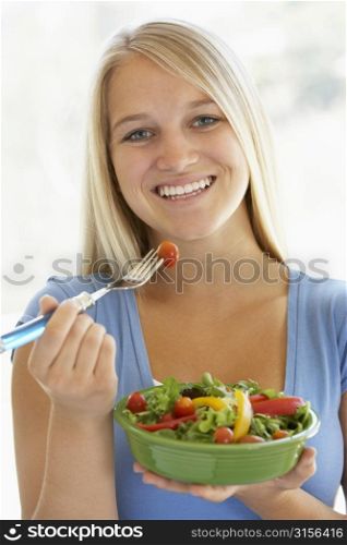 Teenage Girl Eating Fresh Salad