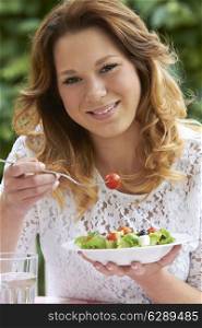 Teenage Girl Eating Healthy Bowl Of Salad
