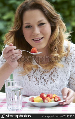 Teenage Girl Eating Healthy Fruit Salad