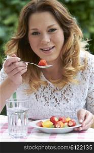 Teenage Girl Eating Healthy Fruit Salad