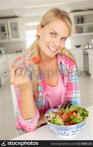 Teenage girl eating salad