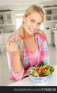 Teenage girl eating salad