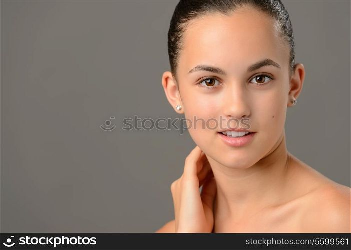 Teenage girl face cosmetics skin care close-up on gray background