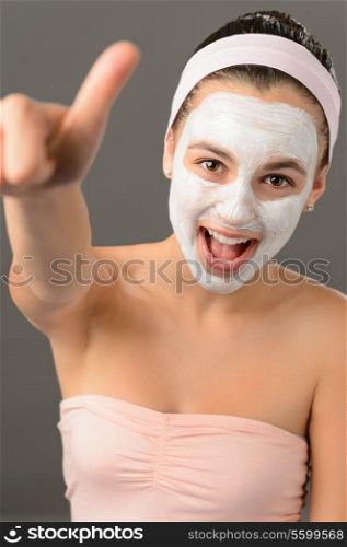 Teenage girl facial mask beauty thumb-up shouting on gray background