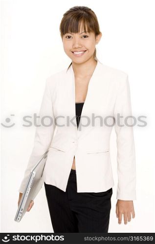 Teenage girl holding a laptop and smiling