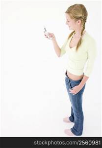 Teenage girl holding cellular phone and smiling