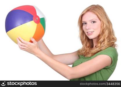 Teenage girl holding inflatable beach ball