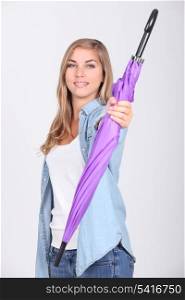 Teenage girl holding purple umbrella