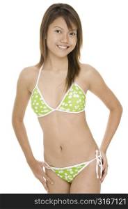 Teenage girl in a bikini standing with her hands on her hip