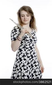 teenage girl in dress holds flute in studio against white background