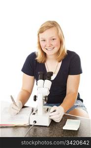 Teenage girl in school, taking notes on what she observed through the microscope. Isolated on white.