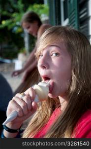 Teenage girl licking an ice cream cone in Belize