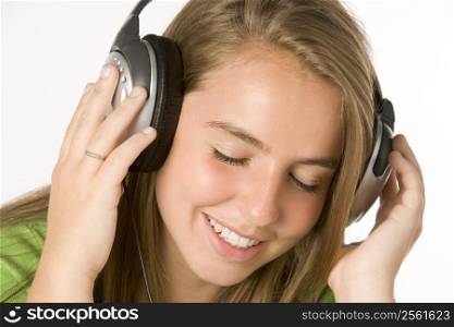 Teenage Girl Listening To Music On Headphones