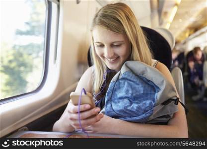 Teenage Girl Listening To Music On Train Journey