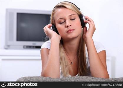Teenage girl listening to music through headphones