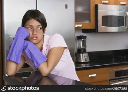 Teenage girl looking sad in the kitchen