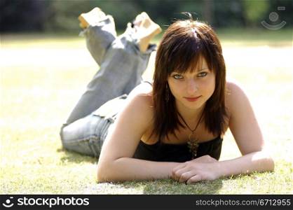 teenage girl lying in park relaxing