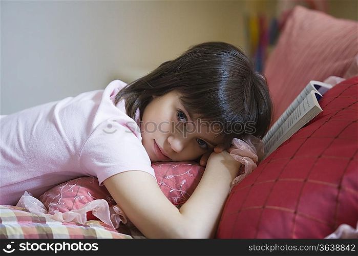 Teenage girl lying on bed
