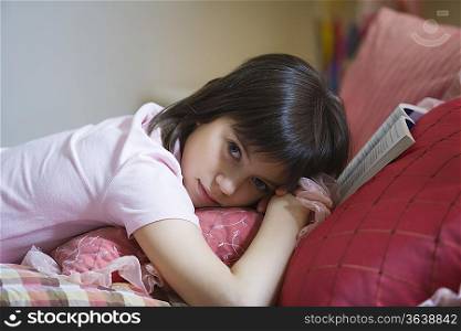 Teenage girl lying on bed