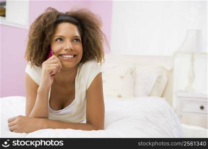 Teenage Girl Lying On Bed Using Cellphone