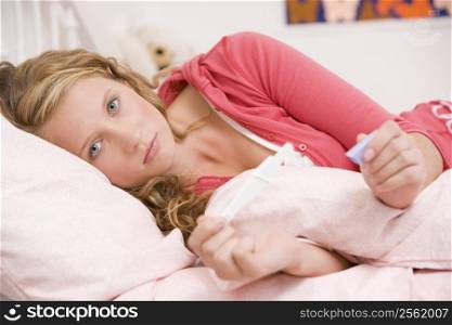 Teenage Girl Lying On Her Bed With A Pregnancy Test