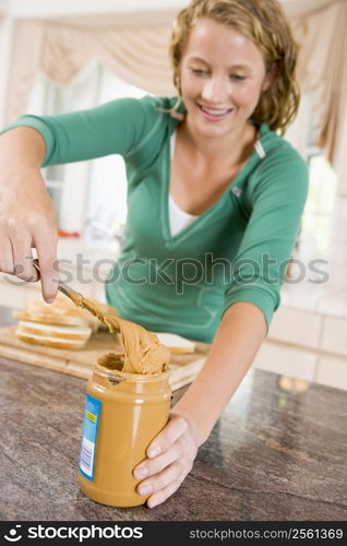 Teenage Girl Making Peanut Butter Sandwich