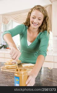 Teenage Girl Making Peanut Butter Sandwich