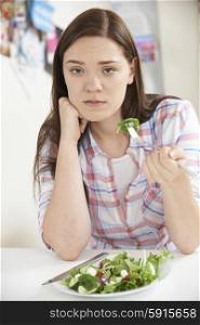 Teenage Girl On Diet Eating Plate Of Salad