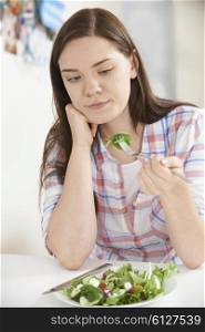 Teenage Girl On Diet Eating Plate Of Salad