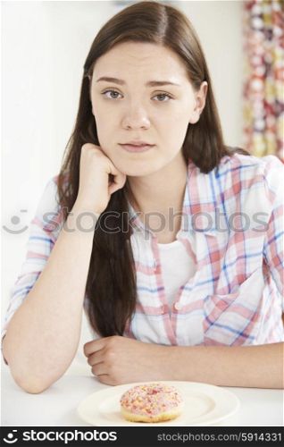 Teenage Girl On Diet Looking At Donut