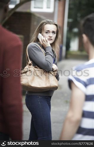 Teenage Girl On Mobile Phone Feeling Intimidated As She Walks Home