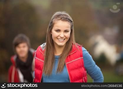 Teenage Girl Outside With Boyfriend In Background