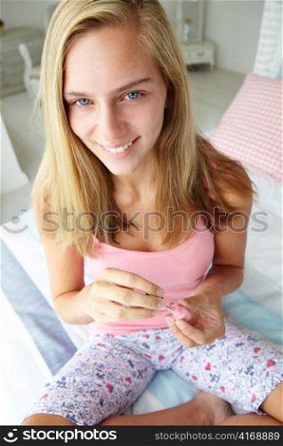 Teenage girl painting nails