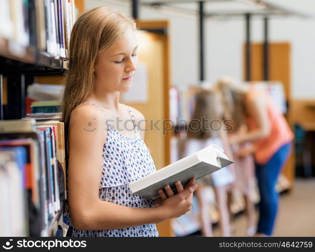 Teenage girl picking a book in public library. That is a difficult choice