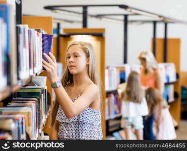 Teenage girl picking a book in public library. That is a difficult choice