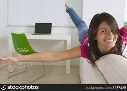 Teenage girl playing on a couch