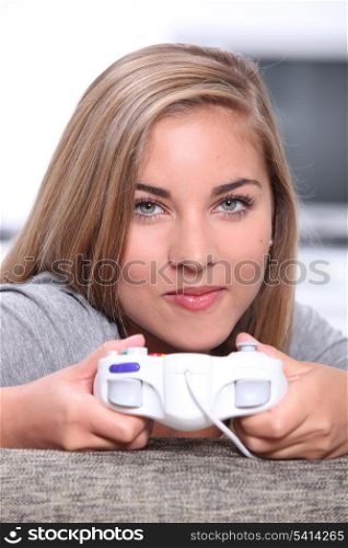 Teenage girl playing on games console