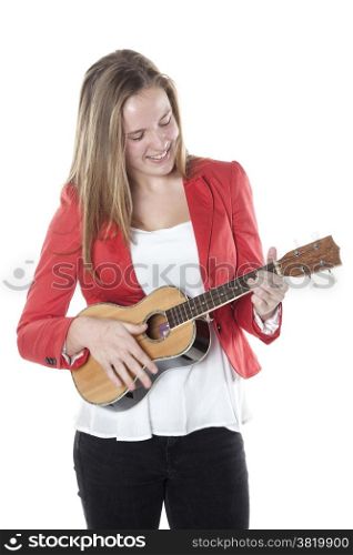 teenage girl plays ukulele in studio against white background