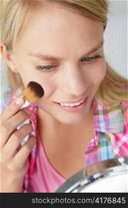 Teenage girl putting on make-up