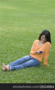 Teenage girl reading a text message on a mobile phone