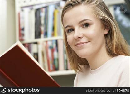 Teenage Girl Reading Book At Home