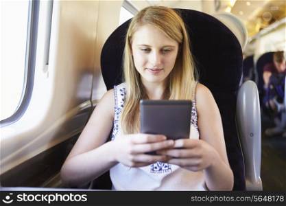 Teenage Girl Reading E Book On Train Journey