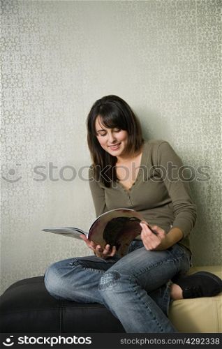 Teenage girl reading magazine