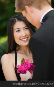 Teenage Girl Receiving Corsage from Date