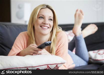 Teenage Girl Relaxing At Home Watching Television