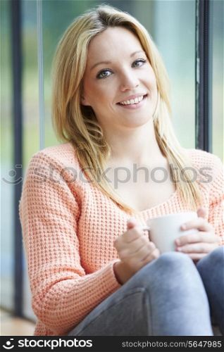 Teenage Girl Relaxing At Home With Hot Drink