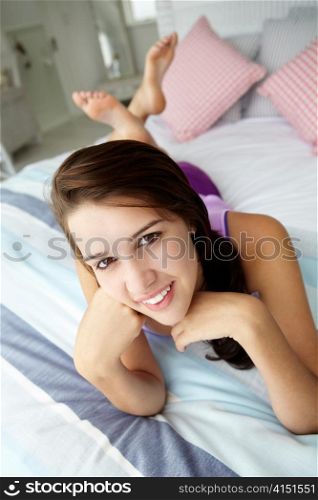 Teenage girl relaxing on bed
