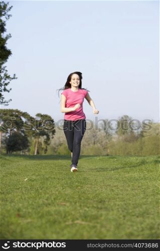 Teenage Girl Running Through Summer Meadow